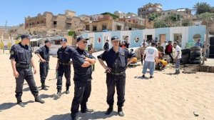 Evening activities at Ain Turk include securing parasols and tables, removing extensions, and lifting fishing boats